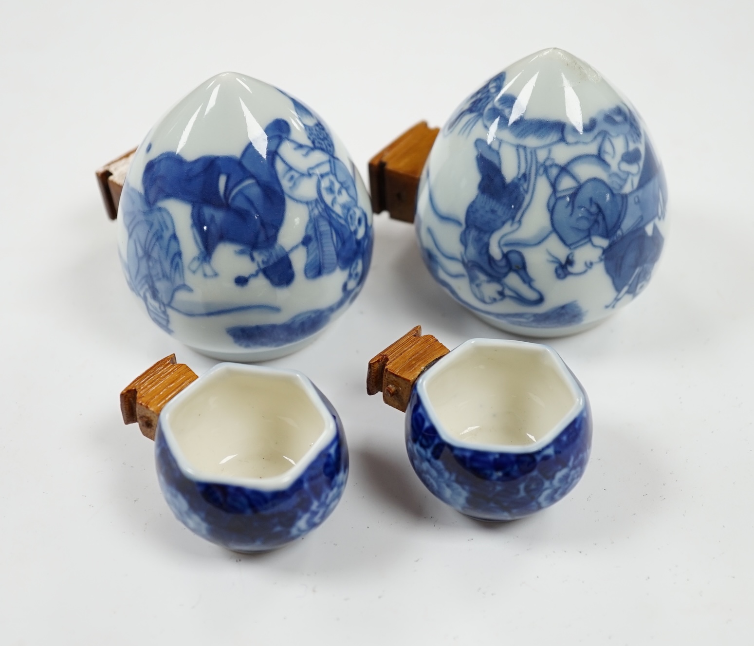 Four Chinese blue and white porcelain bird feeders, largest 7cm high. Condition - good, some glue residue